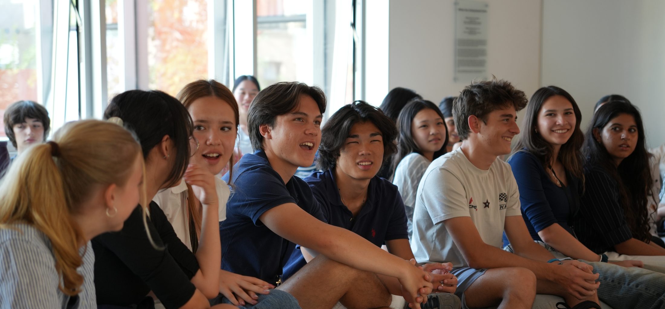 An international group of students listening during an academic session